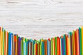 Heap of colorful plastic drinking straws on Colored background, flat lay. Copy Space for text Royalty Free Stock Photo