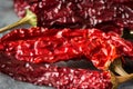Heap of colorful red dried hot chili peppers on dark concrete background, cooking, spices, healthy food, mexican Royalty Free Stock Photo