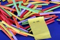 A heap of colorful tombola tickets with a yellow winning number are lying on a blue reflection ground Royalty Free Stock Photo