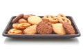 Heap of cookie on black plastic tray, on white