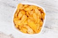 Cornflakes in glass bowl as source carbohydrates and dietary fiber, nutritious eating concept