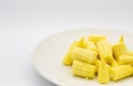 Heap cut baby corn in dish on white background