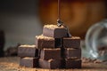 Heap of delicious cubes of bitter dark chocolate sprinkled with cocoa powder and poured with liquid chocolate