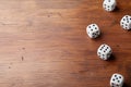 Heap of dice on rustic wooden table. Gambling devices. Game of chance concept. Copy space for text. Royalty Free Stock Photo