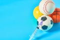 Heap of different balls near syringe on blue background. Concept of doping in professional sport