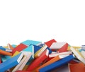 A heap of different books with colorful covers which are laying on the floor.