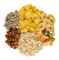 Heap of ingredients for muesli dried fruits, corn flakes, oatmeal, sunflower seeds, banana chips isolated on white. Top view Royalty Free Stock Photo