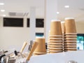 Heap of disposable reclying paper cup on coffee machine
