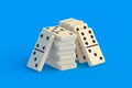 Heap of dominoes tiles on turquoise background Royalty Free Stock Photo