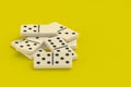 Heap of dominoes tiles on yellow background Royalty Free Stock Photo