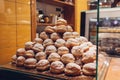 Heap of doughnuts on cafe showcase. Pile of desserts with sugar powder on shelf in store. Royalty Free Stock Photo