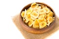 Heap of dried banana chips snack in wooden bowl over white Royalty Free Stock Photo