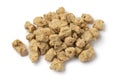 Heap of dried soya chunks close up on white background