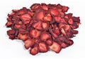 Heap of dried strawberries on a white