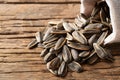 Heap of Dried sunflower seeds in the sack on wood plate Royalty Free Stock Photo