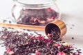 Heap of dry black tea with vanilla, cranberries, rose petals, pineapple on a wooden surface. Measuring Spoon For Tea