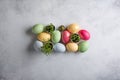 Heap of dyed multi-colored eggs and green sprouts in egg shell  on concrete background. Top view, copy space. Food background. Royalty Free Stock Photo