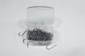 Heap of fishhooks stacked in a plastic box