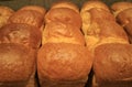 Heap of fluffy fresh baked bread loaves, closed up for background