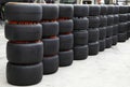 Heap of Formula 1 vehicle tyres in front of Pit stop garage