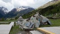 a pile of broken rocks sitting on the side of a road