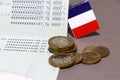 Heap of French franc coin money and mini France flag on the book bank. Concept of Saving money