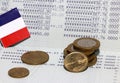 Heap of French franc coin money and mini France flag on the book bank. Concept of Saving money