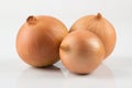 Heap of fresh beige onion bulb on white background.