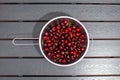 heap of fresh cherries in metal strainer Royalty Free Stock Photo