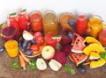 Heap of fresh fruits and freshly prepared cocktails of different colors on a wooden table with a white background. Rustic style