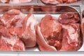Heap of fresh meat food meat food background in supermarket store. Different types of raw meat in plastic boxes, leg of Royalty Free Stock Photo