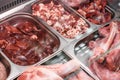 Heap of fresh meat food meat food background in supermarket store. Different types of raw meat in plastic boxes, leg of Royalty Free Stock Photo