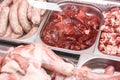 Heap of fresh meat food meat food background in supermarket store. Different types of raw meat in plastic boxes, leg of Royalty Free Stock Photo