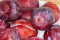 Heap of fresh washed plums close-up in selective focus Royalty Free Stock Photo