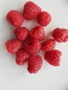 Heap of fresh whole raspberries on plate