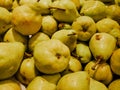Heap of fresh yellow pears for sale in the market close up top view