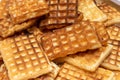 Heap of golden homemade Belgian Waffles on a plate close up for breakfast or a snack