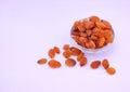 Heap of golden sultana raisins in a glass bowl isolated on white background