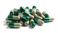 Heap of green spirulina capsules on white background. Royalty Free Stock Photo