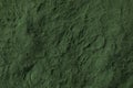 Heap of green spirulina powder close up full frame