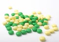 A heap of green and yellow medicine pills. Royalty Free Stock Photo