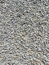 Heap of grey dry round stones background, top view. Royalty Free Stock Photo