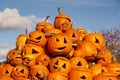 A heap of halloween pumpkins against a blue sky. Royalty Free Stock Photo