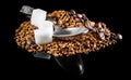 Heap of instant coffee with coffee beans, cubes of sugar and teaspoon on black Royalty Free Stock Photo