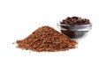 Heap of instant coffee and glass bowl with beans on white background