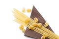 Heap of italian macaroni shells and spaghetti on brown napkin