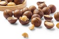Heap of macadamia nuts with cracked nut and shell isolated on white background Royalty Free Stock Photo