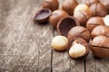 Heap of macadamia nuts on wooden rustic table.