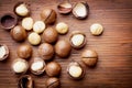 Heap of macadamia nuts on wooden table top view.