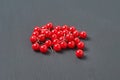 Heap of many red push pins on dark concrete desk in office, school or home Royalty Free Stock Photo